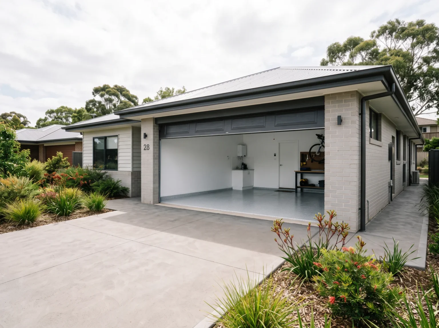 Contemporary Australian home with an open double garage, coated flake concrete floor and a plain concrete driveway