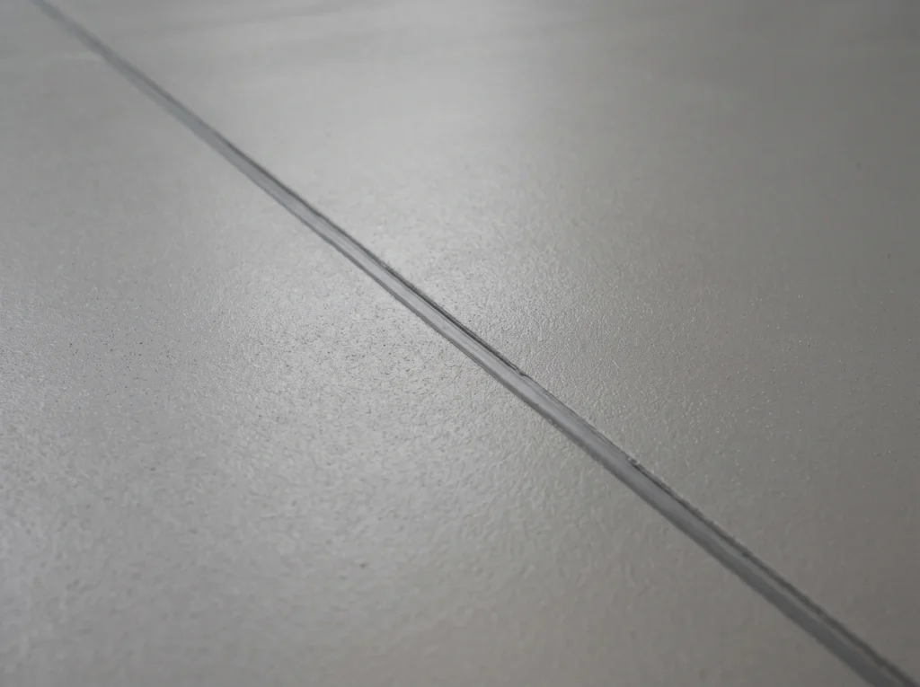 Solid mid grey industrial floor coating with a clean expansion joint